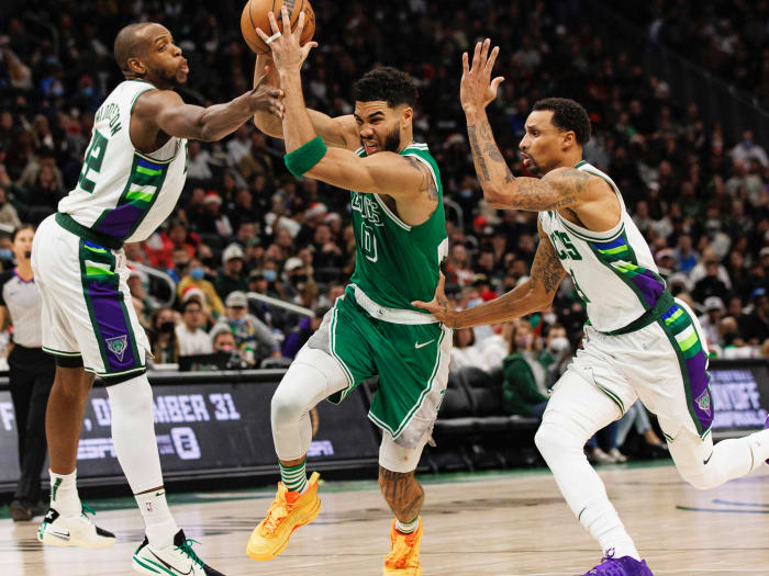 Boston Celtics forward Jayson Tatum (0) drives for the basket between Milwaukee Bucks forward Khris Middleton (22) and guard George Hill (3) during the fourth quarter at Fiserv Forum.