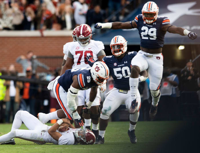 Auburn Tigers defensive end Colby Wooden (25), defensive lineman Marcus Harris (50) and defensive lineman Derick Hall (29) celebrate a sack against Alabama quarterback Bryce Young (9) during the Iron Bowl at Jordan-Hare Stadium in Auburn, Ala., on Saturday, Nov. 27, 2021. Ncaa Football Alabamaat Auburn