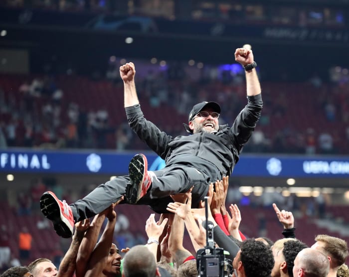 Liverpool manager Jurgen Klopp pictured celebrating with his team after winning the 2019 Champions League final against Tottenham