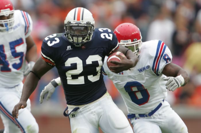 Oct 9, 2004; Auburn, AL, USA; Auburn Tigers running back #23 Ronnie Brown runs through the Louisiana Tech Bulldogs defensive line in 1st half action at Jordan-Hare Stadium. Mandatory Credit: Photo By Jason Parkhurst-USA TODAY Sports Copyright (c) 2004 Jason Parkhurst