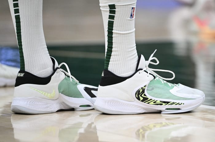 View of white and green Nike Zoom Freak shoes.