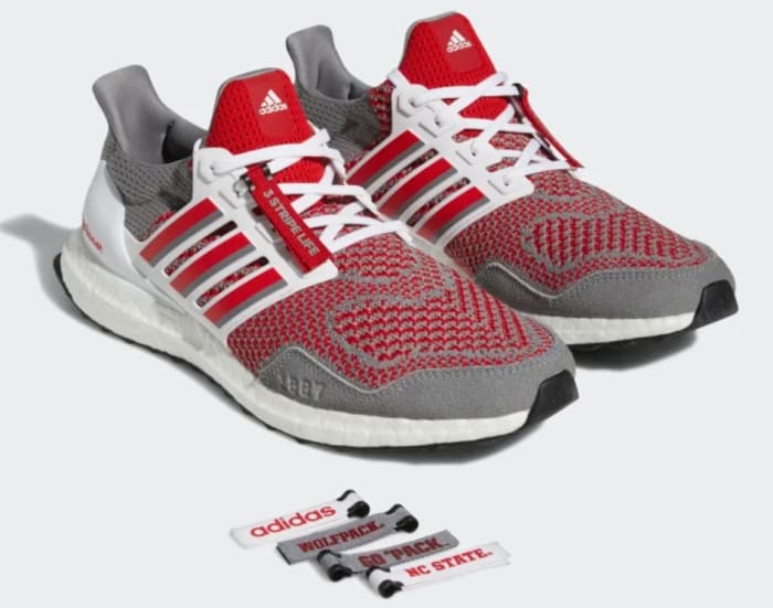 View of grey and red adidas shoes.