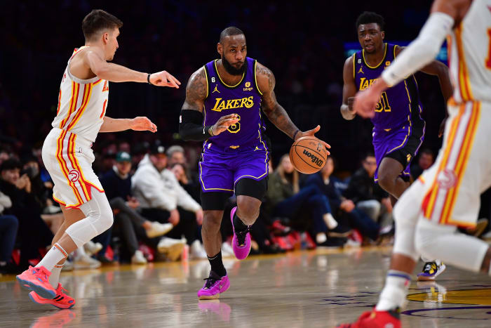 Lakers forward LeBron James dribbles the ball up the court against the Hawks.