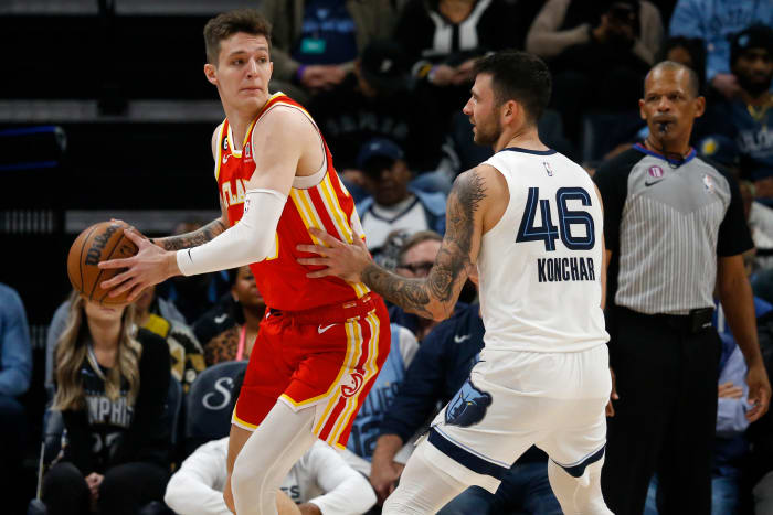 Hawks guard Vitt Kreich passes the ball around Grizzlies guard John Concher.