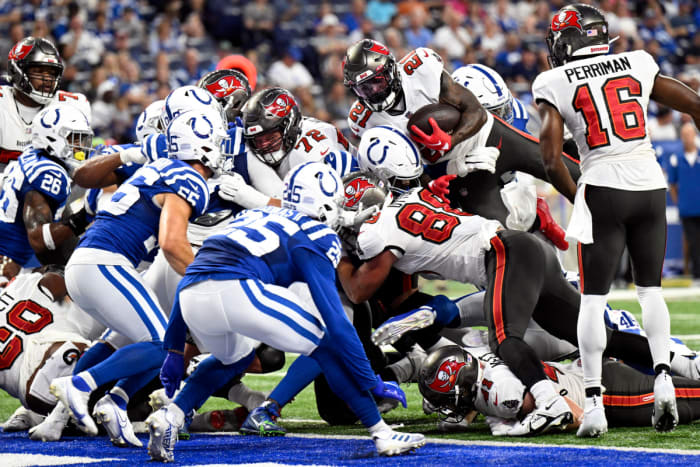 Aug 27, 2022; Indianapolis, Indiana, USA; Tampa Bay Buccaneers running back Ke'Shawn Vaughn (21) jumps into the line looking for a touchdown during the second quarter against the Indianapolis Colts at Lucas Oil Stadium.