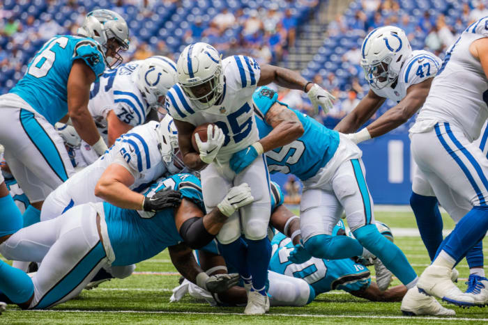 Aug 15, 2021; Indianapolis, Indiana, USA; Indianapolis Colts running back Deon Jackson (35) runs the ball while Carolina Panthers linebacker Christian Miller (55) defends in the second half at Lucas Oil Stadium.