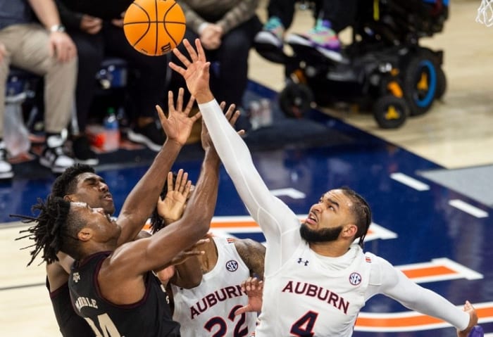 Auburn Tigers forward Johnny Bloom, 4, takes on Texas A&M Aggies forward Julius Marble, 34, as the Auburn Tigers face the Texas A&M Aggies on Wednesday, January 25, 2023 at Neville Arena in Auburn, Alabama. block. The Texas A&M Aggies defeated the Auburn Tigers.  79-63.