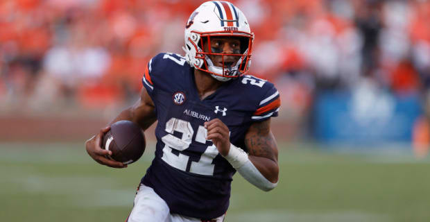 During a college football game in the SEC, Auburn Tigers tailback Harquez Hunter attempts a rushing attempt.