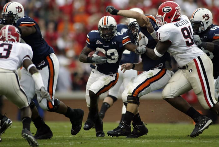 Nov 11, 2006; Auburn, AL, USA. Auburn Tigers running back Kenny Irons (23) tries to find a hole as Georgia Bulldogs defensive tackle Kade Weston (91) closes in at Jordan-Hare Stadium in Auburn. Mandatory Credit: Photo By John Reed-USA TODAY Sports