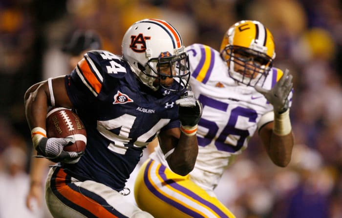 Oct. 24, 2009; Baton Rouge, LA, USA; Auburn Tigers running back Ben Tate (44) runs past LSU Tigers linebacker Perry Riley (56) during the second half at Tiger Stadium. LSU defeated Auburn 31-10. Mandatory Credit: Matt Stamey-USA TODAY Sports