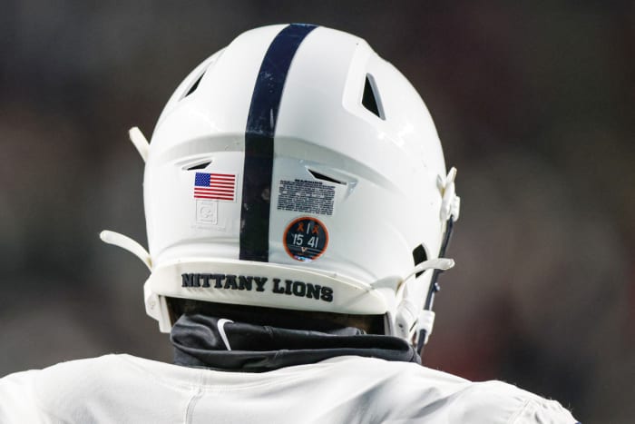 November 19, 2022;  Piscataway, New Jersey, USA;  A Penn State Nittany Lions helmet is seen with a sticker honoring the Virginia football players who were victims of the University of Virginia campus shooting, Nov. 13, 2022, during the second half against the Rutgers Scarlet Knights at SHI Stadium.  Mandatory Credit: Vincent Carchietta-USA TODAY Sports