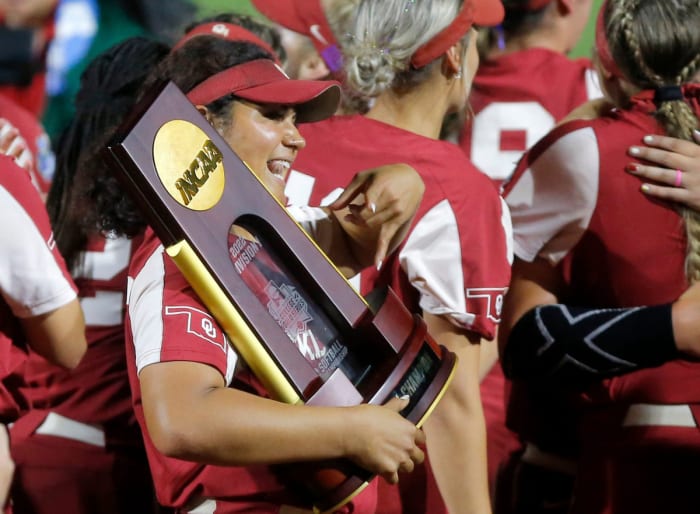 Jocelyn Alo, with a national championship trophy and the horns down