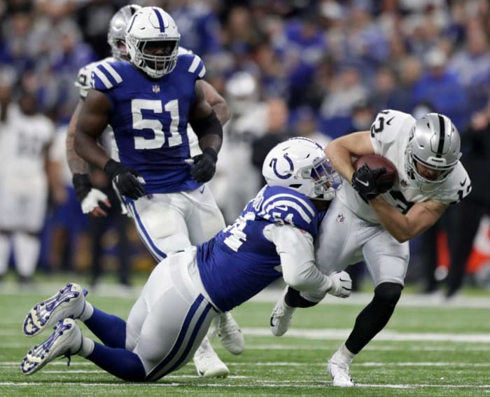 Indianapolis Colts defensive end Dayo Odeyingbo (54) works to bring down Las Vegas Raiders wide receiver Hunter Renfrow (13) on Sunday, Jan. 2, 2022, during a game at Lucas Oil Stadium in Indianapolis.