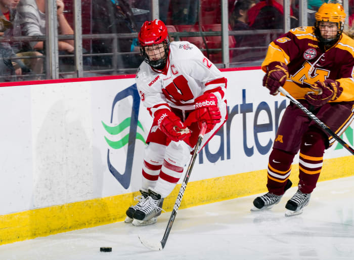 Women's hockey star Hilary Knight skating maneuvering down the ice against Minnesota