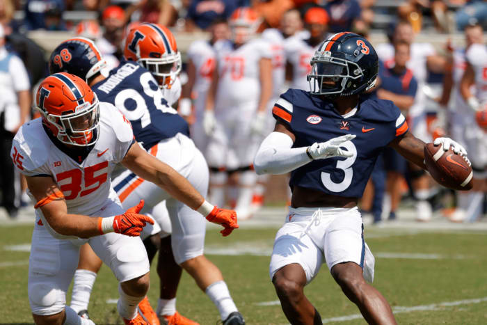 Virginia Cavaliers wide receiver Dontayvion Wicks (3) passes the ball as Illinois Fighting Illini linebacker Jake Hansen (35) chases in the third quarter at Scott Stadium.