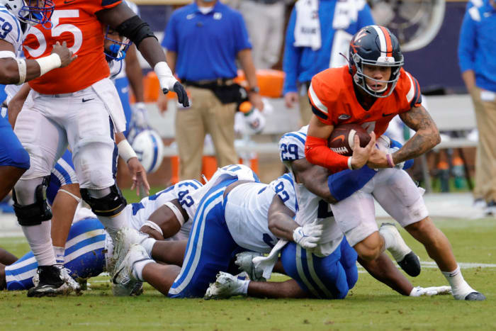 Virginia Cavaliers wide receiver Billy Kemp IV (4) is tackled while carrying the ball by Duke Blue Devils safety Nate Thompson (29) during the second quarter at Scott Stadium.