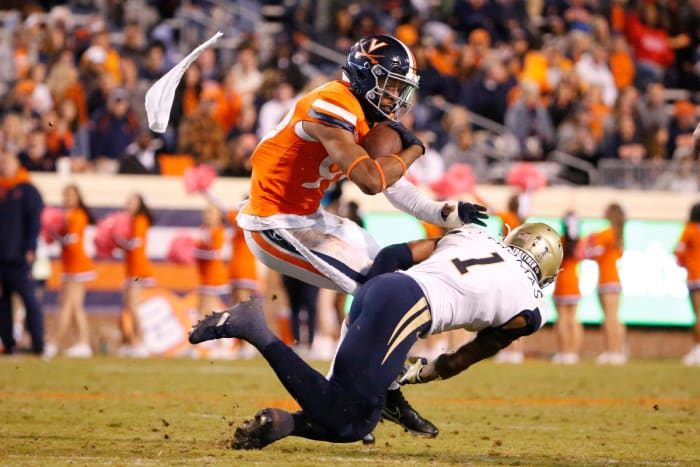 Virginia Cavaliers wide receiver Keytaon Thompson (99) carries the ball as Georgia Tech Yellow Jackets defensive back Juanyeh Thomas (1) defends during the fourth quarter at Scott Stadium.