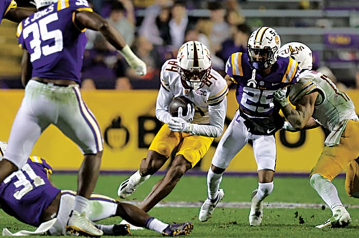 Louisiana Monroe Warhawks wide receiver Jahmeel Rice (84) rushes against LSU Tigers safety Cameron Lewis (31) and LSU Tigers cornerback Cordale Flott (25) during the second half at Tiger Stadium.
