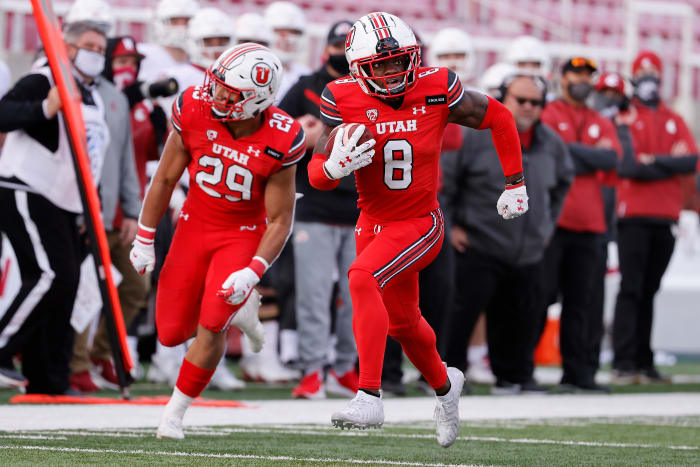 Utah Utes cornerback Clark Phillips III (8) runs back an interception for a touchdown in the fourth quarter against the Washington State Cougars at Rice-Eccles Stadium