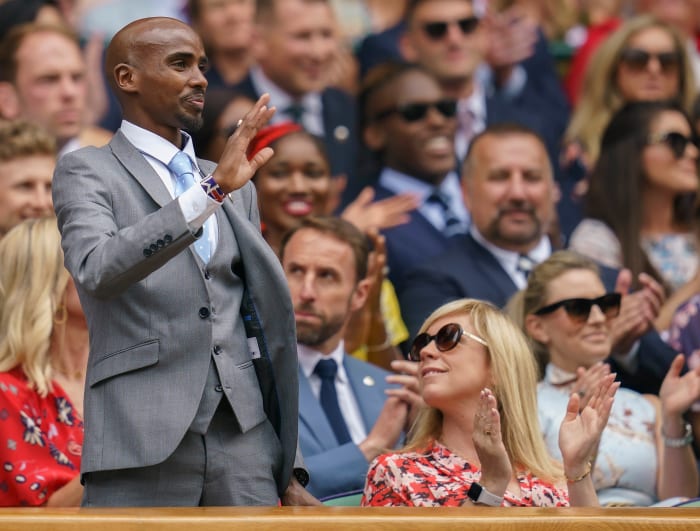 British track star Mo Farah waves to the crowd at Wimbledon in 2019.