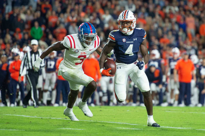 AUBURN, ALABAMA - OCTOBER 30: Running back Tank Bigsby #4 of the Auburn Tigers runs the ball by defensive back Otis Reese #3 of the Mississippi Rebels during the first quarter of play at Jordan-Hare Stadium on October 30, 2021 in Auburn, Alabama. (Photo by Michael Chang/Getty Images)