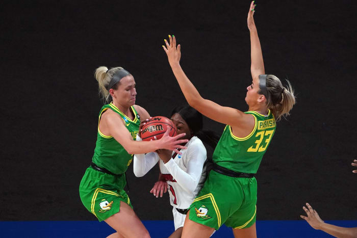 Sydney Parrish and Maddie Cher defend against Louisville Cardinals guard Dana Evans in the first quarter of the Sweet Sixteen of the 2021 Women's NCAA Tournament at the Alamodome.