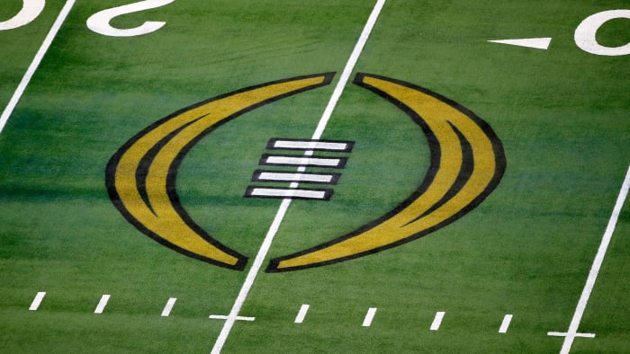 The college football playoff logo is painted on the field.