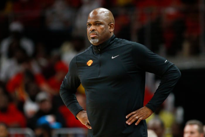 Nate McMillan stands on the sideline during a game.
