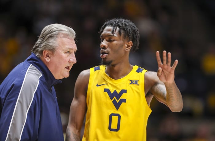 Jan 18, 2022; Morgantown, West Virginia, USA; West Virginia Mountaineers head coach Bob Huggins talks with West Virginia Mountaineers guard Kedrian Johnson (0) during the first half against the Baylor Bears at WVU Coliseum.