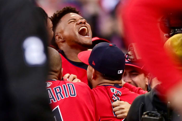 Óscar González celebrates with his teammates after his 15th inning walk-off home run clinched the AL Wild-Card Series for the Guardians.