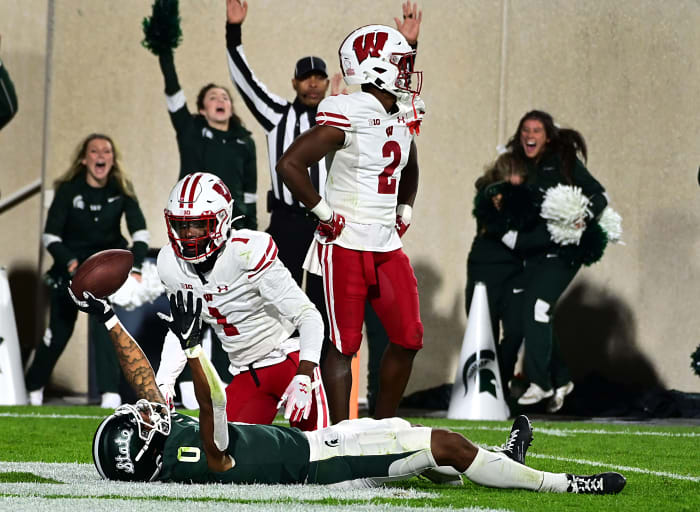 Wisconsin cornerbacks Ricardo Hallman and Jay Shaw looking on as MSU Keon Coleman celebrates a touchdown.