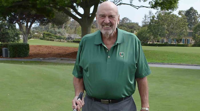 Golf equipment innovator Barney Adams is pictured on a golf course.