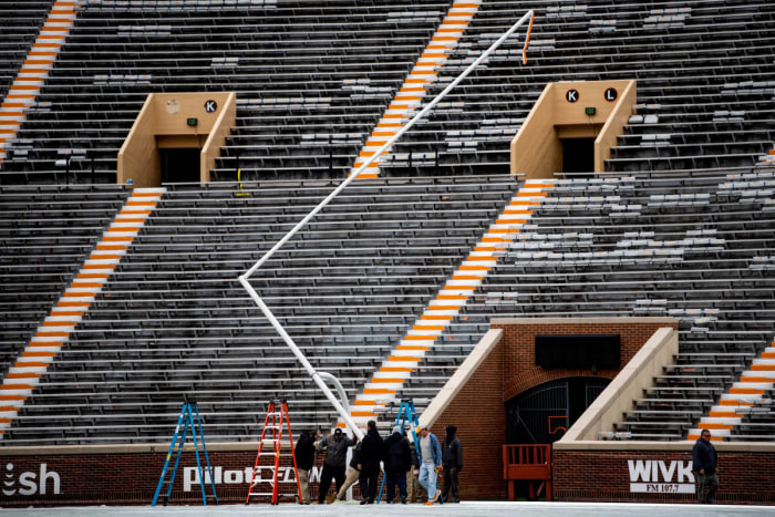 Workers erect new goalposts at Neyland Stadium.