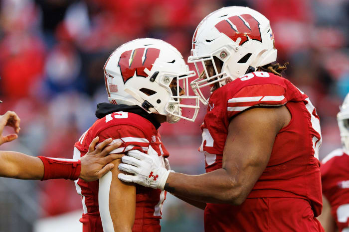 Wisconsin defensive players Rodas Johnson and Kamo'i Latu celebrate a big hit against Maryland.