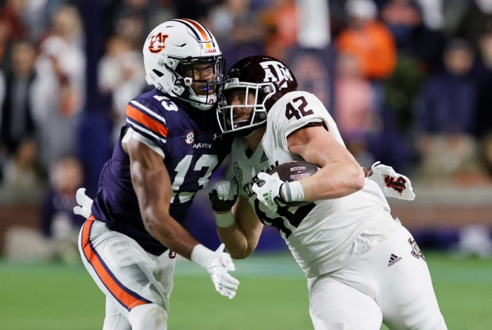 Nov 12, 2022; Auburn, Alabama, USA; Texas A&M Aggies tight end Max Wright (42) is tackled by Auburn Tigers linebacker Cam Riley (13) during the second quarter at Jordan-Hare stadium. Mandatory Credit: John Reed-USA TODAY Sports