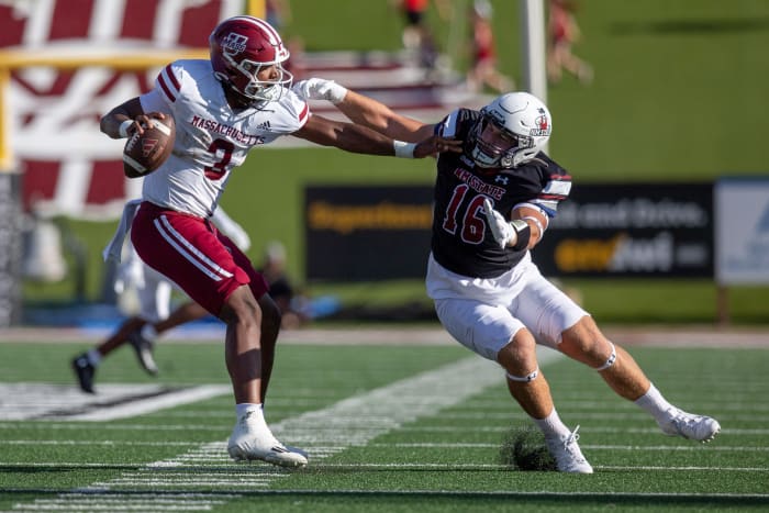 Aggie linebacker Gabe Peterson reaches for UMass quarterback Taisun Phommachanh during an Aggie football game on Saturday, August 256 2023, at the Aggie Memorial Stadium.