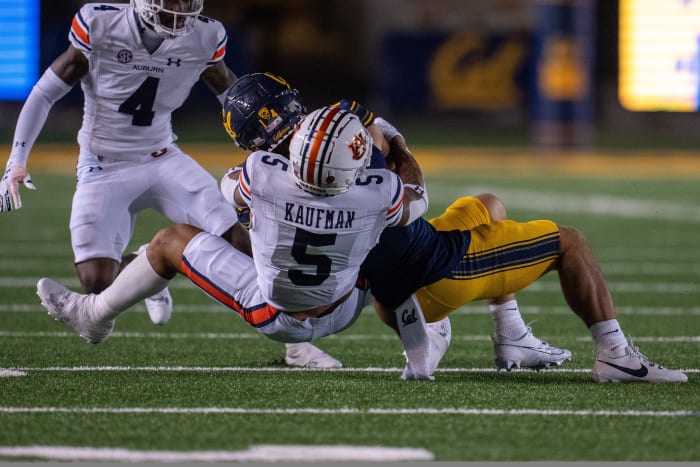 Sep 9, 2023; Berkeley, California, USA; California Golden Bears wide receiver Monroe Young (14) is tackled by Auburn Tigers safety Donovan Kaufman (5) during the second quarter at California Memorial Stadium. Mandatory Credit: Neville E. Guard-USA TODAY Sports