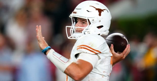 Texas Longhorns quarterback Quinn Ewers attempts a pass during a college football game.