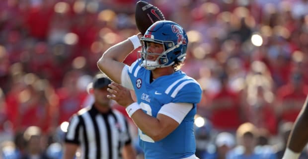 Ole Miss Rebels quarterback Jackson Dart attempts a pass during an SEC college football game.