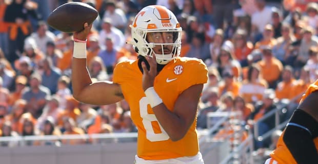 Tennessee Volunteers quarterback Nico Iamareaba attempts a pass during a college football game in the SEC.