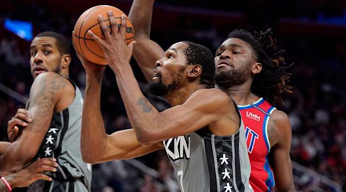 Brooklyn Nets forward Kevin Durant (7) attempts a layup as Detroit Pistons center Isaiah Stewart defends during the second half of an NBA basketball game, Sunday, Dec. 12, 2021, in Detroit.