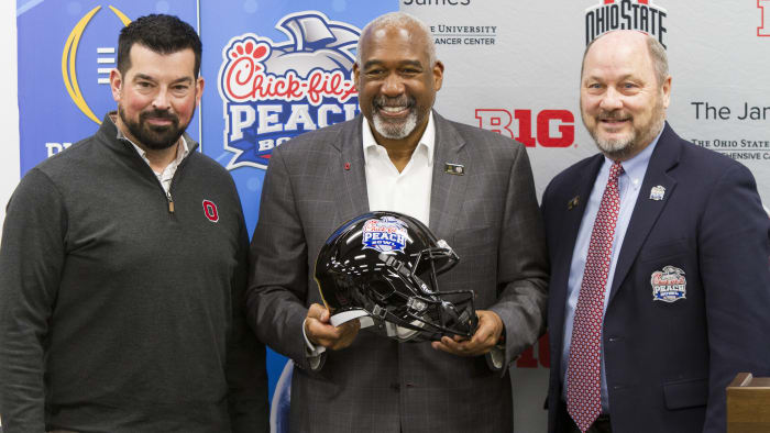 Ryan Day, Gene Smith and Peach Bowl CEO Gary Stokan pose for a photo at the Woody Hayes Athletic Center after the Buckeyes formally accepted an invitation to play at the CFP in Atlanta.