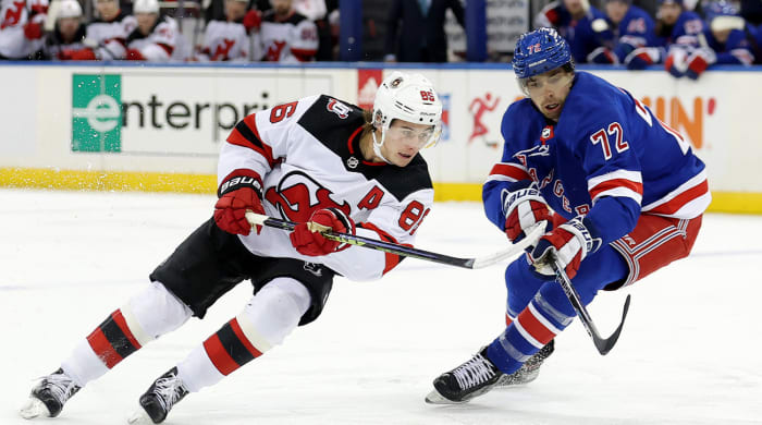 Dec 12, 2022;  New York, New York, USA;  New Jersey Devils center Jack Hughes (86) fights for the puck against New York Rangers center Filip Chytil (72) during the first period at Madison Square Garden.