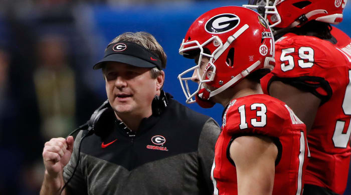 Georgia coach Kirby Smart beats Georgia quarterback Stetson Bennett during the second half of the Chick-fil-A Peach Bowl NCAA college football playoff semifinal game between Ohio and Georgia on Saturday, Dec. 31, 2022 in Atlanta. (13) and talk.