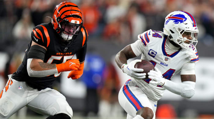 Buffalo Bills wide receiver Stefon Diggs (14) turns towndield after completing a catch as Cincinnati Bengals linebacker Logan Wilson (55) defends in the first quarter of a Week 17 NFL game, Monday, Jan. 2, 2023, at Paycor Stadium in Cincinnati.