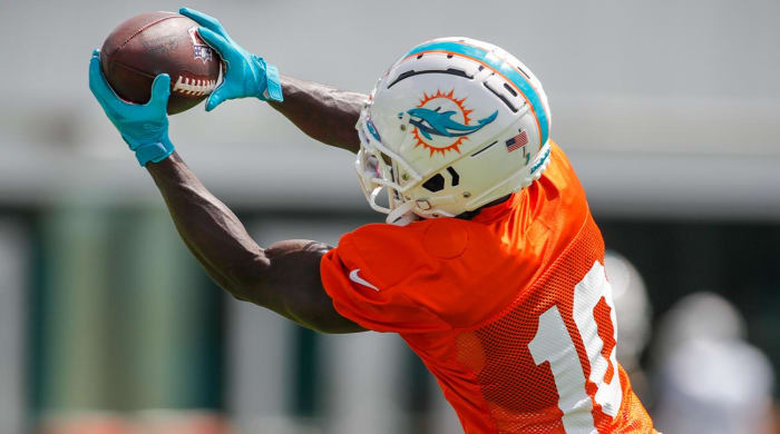 Aug 1, 2022;  Miami Gardens, Florida, US;  Miami Dolphins wide receiver Tyreek Hill (10) catches the football during training camp at Baptist Health Training Complex.