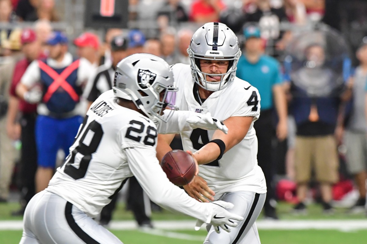 Oakland Raiders running back Josh Jacobs (28) breaks a tackle and