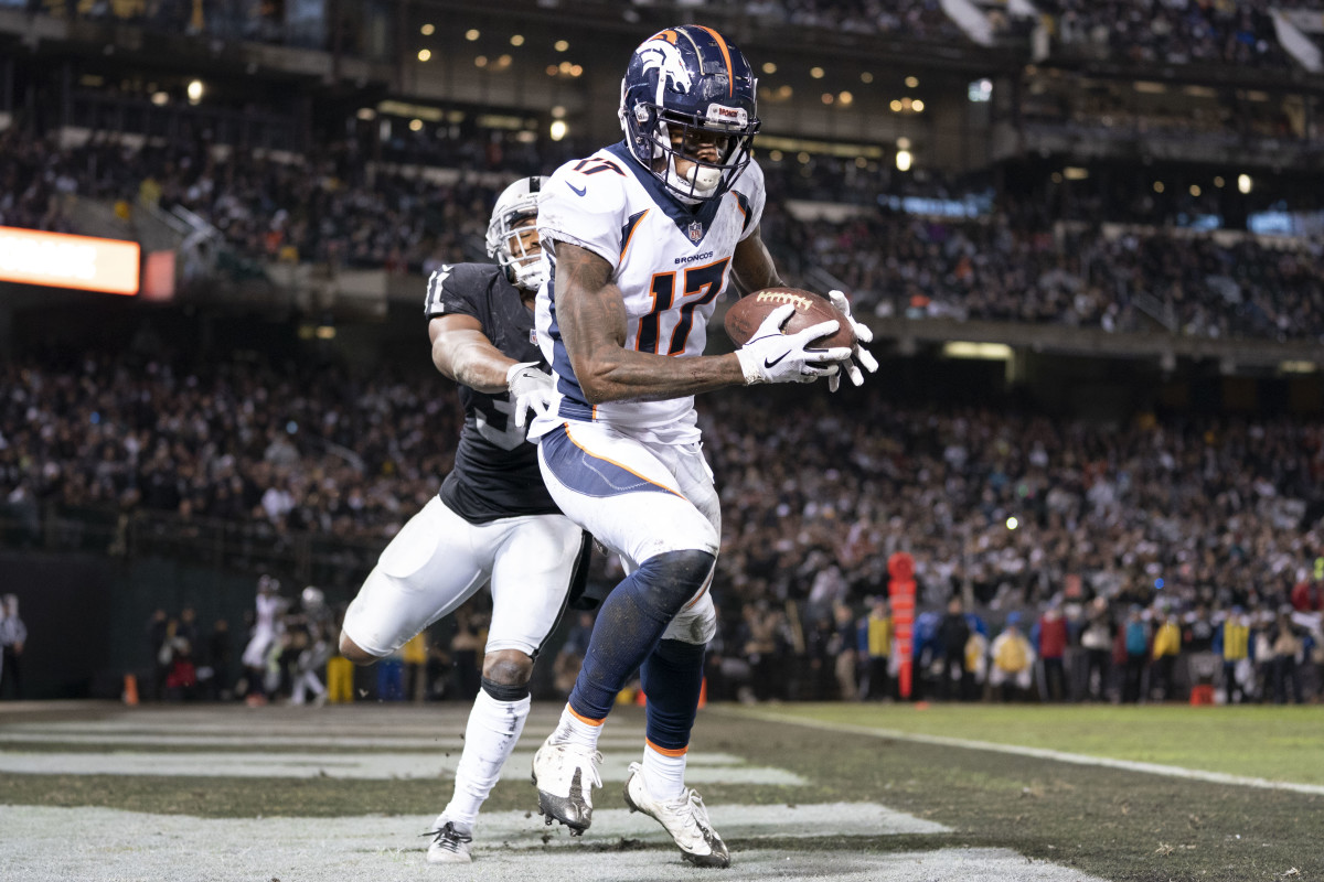 Denver Broncos wide receiver DaeSean Hamilton (17) catches a touchdown pass against Oakland Raiders strong safety Marcus Gilchrist (31) during the third quarter at Oakland Coliseum.