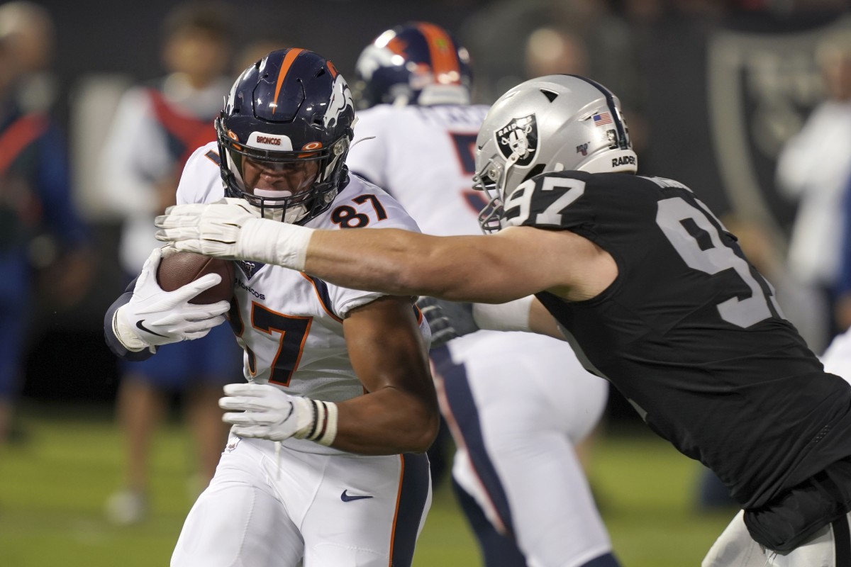 Denver Broncos tight end Noah Fant (87) is defended by Oakland Raiders defensive end Josh Mauro (97) jn the first qauretrat Oakland-Alameda County Coliseum.