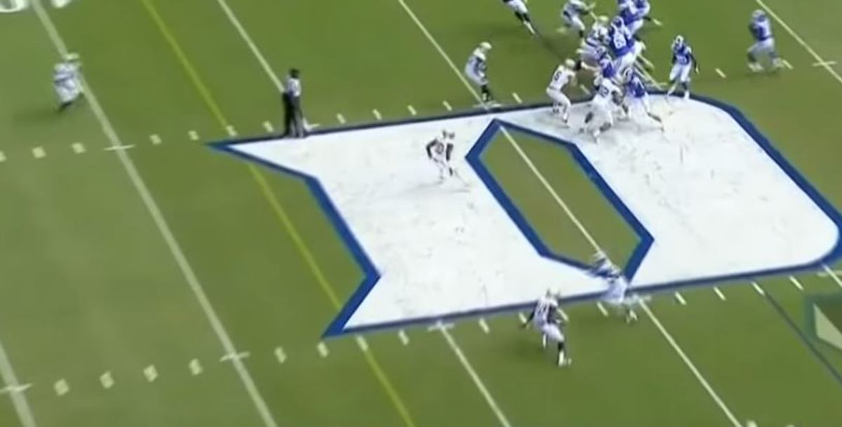 The safety (the blur in the top left) begins heading toward the other hash, far downfield